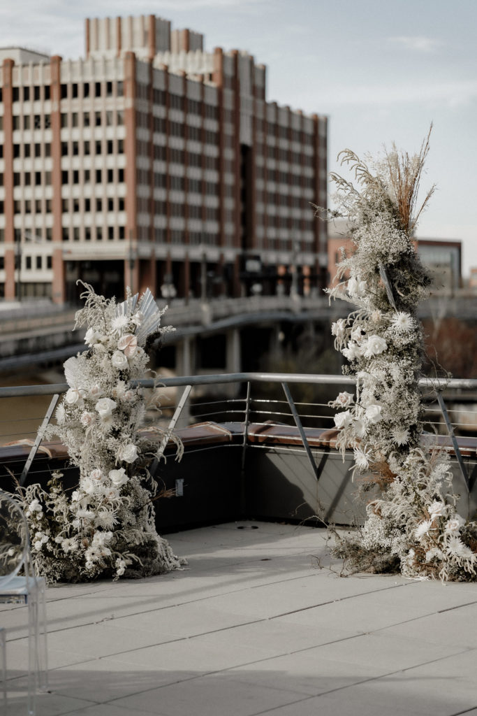 industrial chic rooftop wedding ceremony in Houston, Texas with dried floral column installations