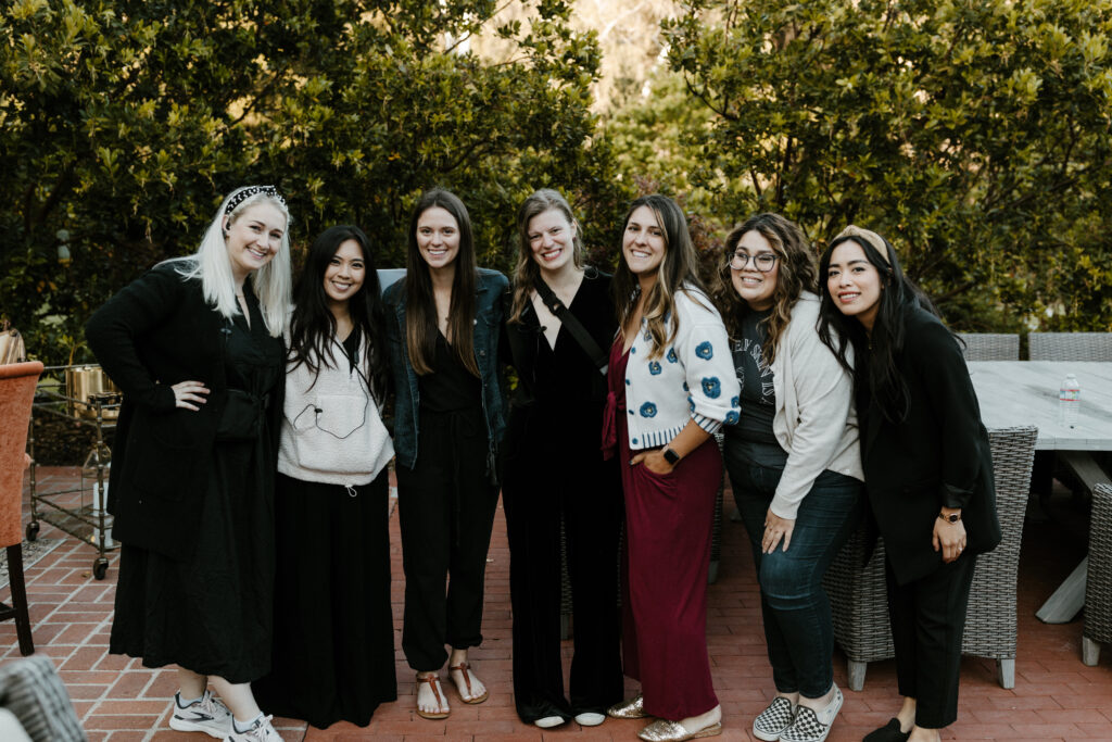A couple of wedding professionals pose as a group while waiting for their vendor meals at a wedding in Carmel Valley, California 